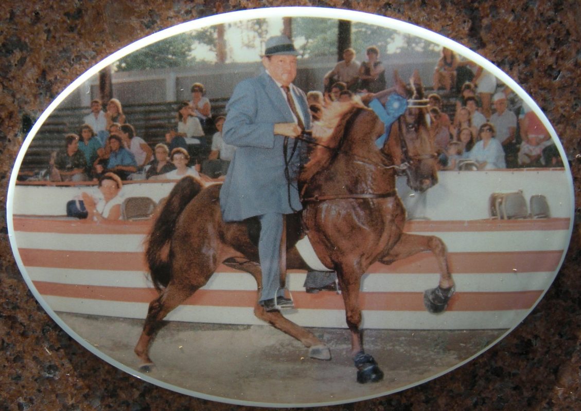 Tom Nickell riding a horse at a show